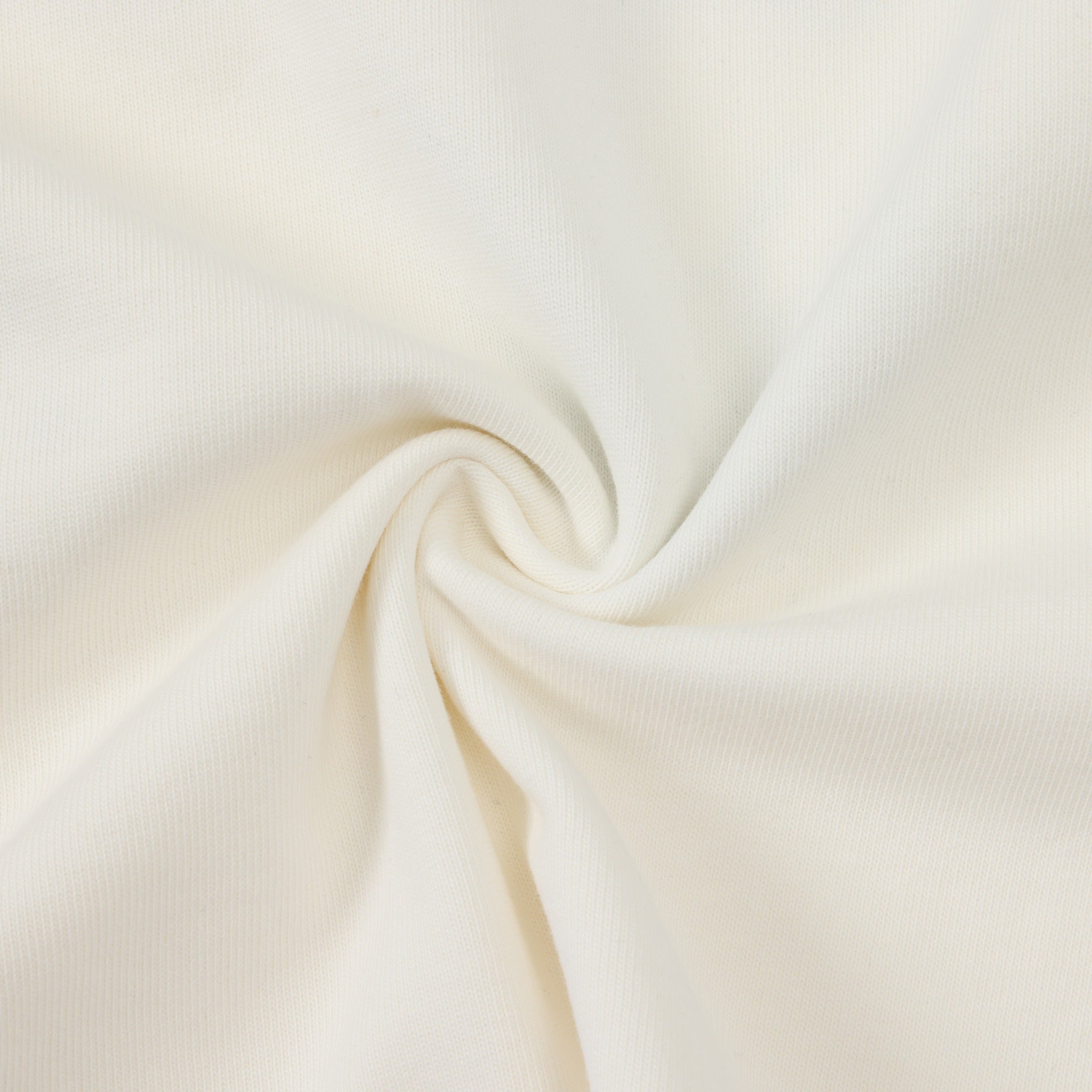 Members Tee – Cream – Close-up of cream fabric twisted to show texture