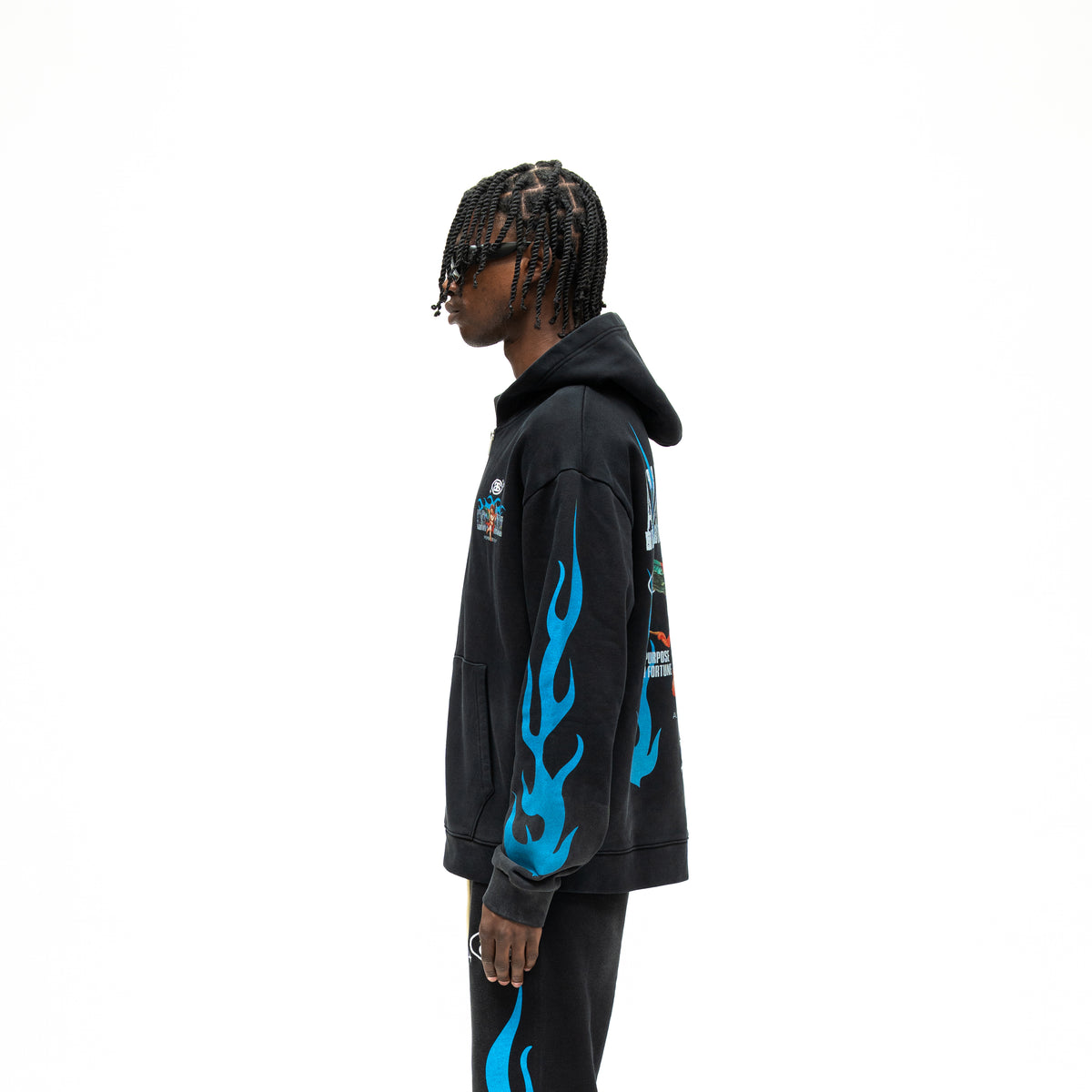 Members Zip Hoodie – Black – Side view on model showing hood, blue flame sleeve graphic, and ribbed cuff and hem