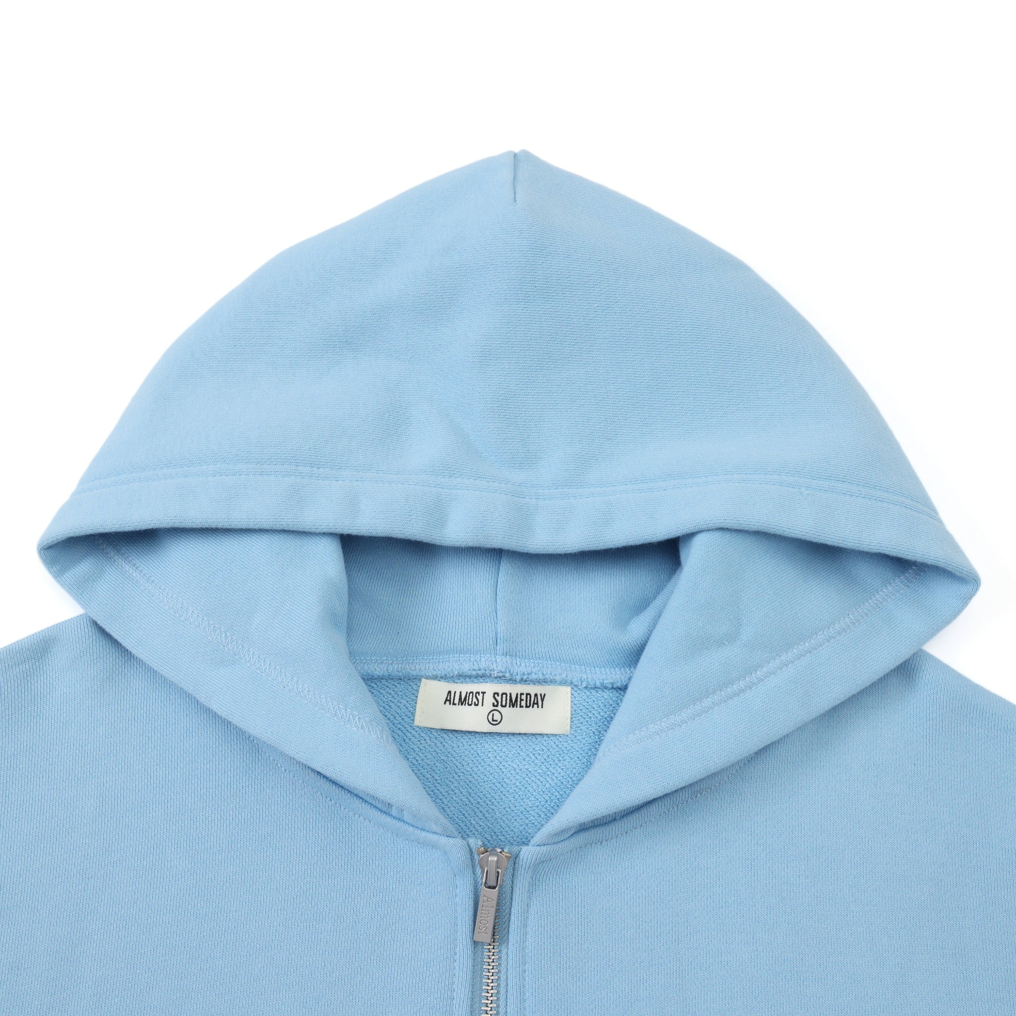 Members Zip Hoodie – Light Blue – Close-up of hood, interior brand label, and metal zipper pull