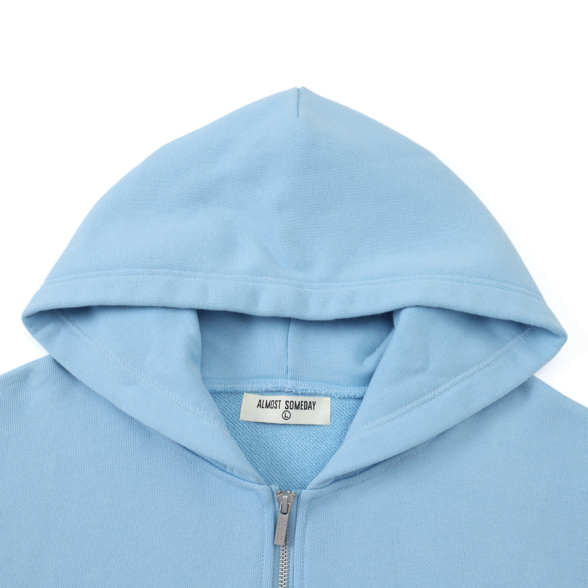 Members Zip Hoodie – Light Blue – Close-up of hood, interior brand label, and metal zipper pull