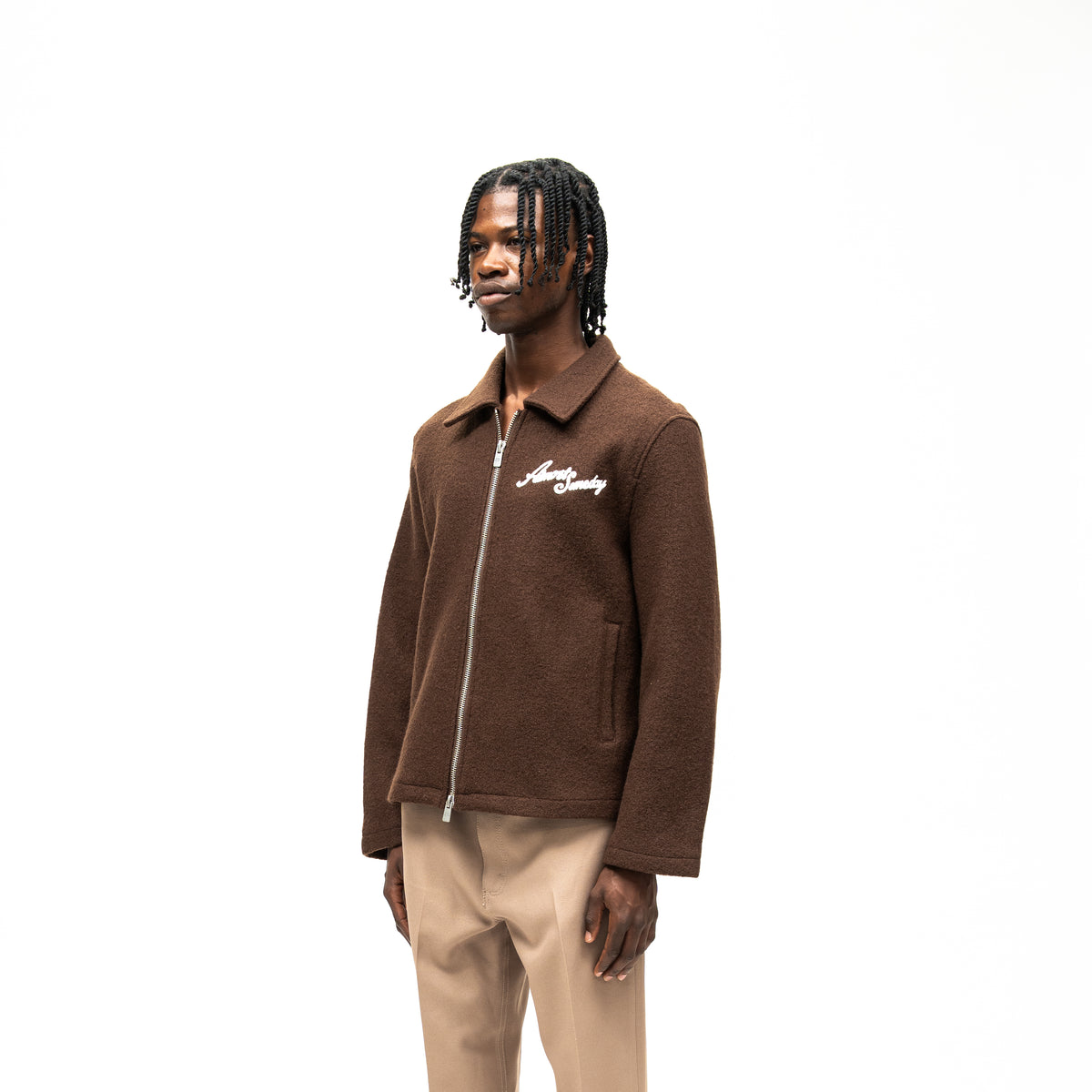 Saint Cropped Wool Jacket – Brown – Three-quarter front view on model showing white chest lettering, side pocket, and cropped hem
