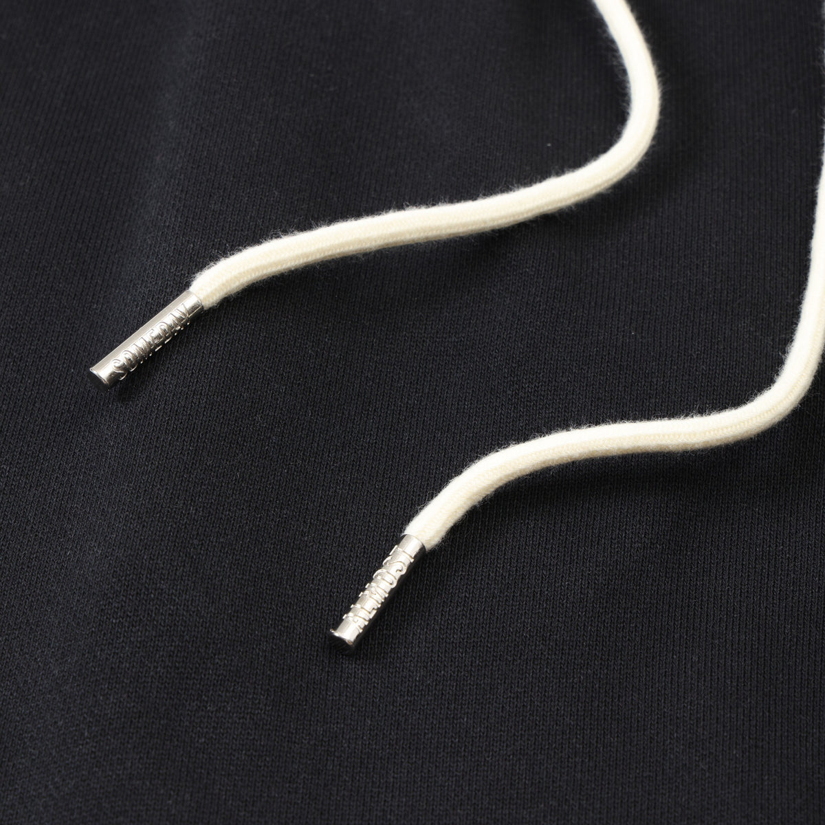 Smoke Flare Bottoms – Black – Close-up of cream drawstrings with silver-tone metal tips on black fabric