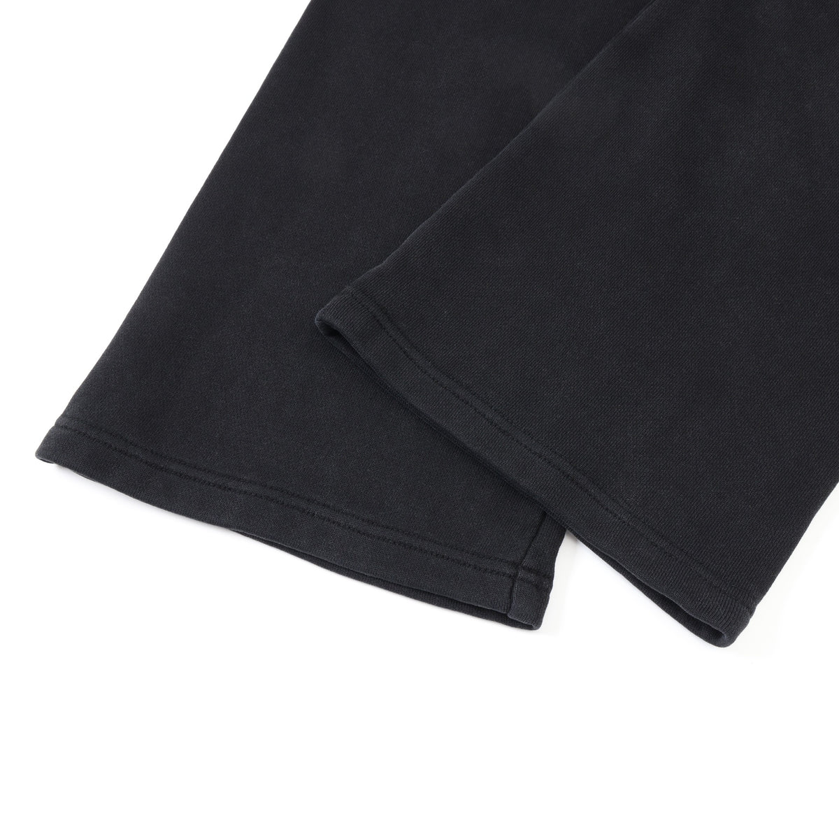 Smoke Flare Bottoms – Black – Close-up of overlapping flared hems and tonal stitching
