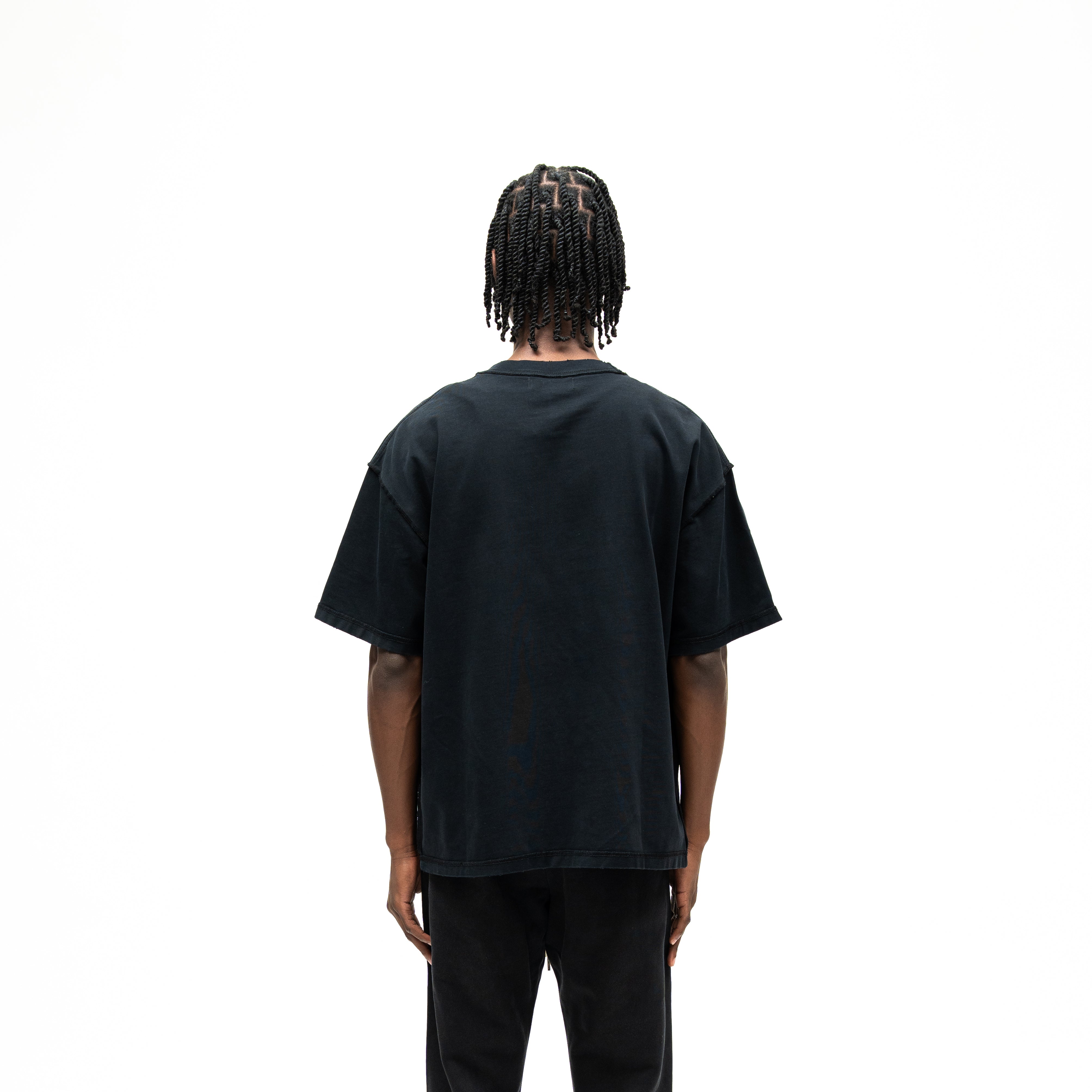 Smoke Tee – Black – Back view on model showing plain black back and relaxed silhouette