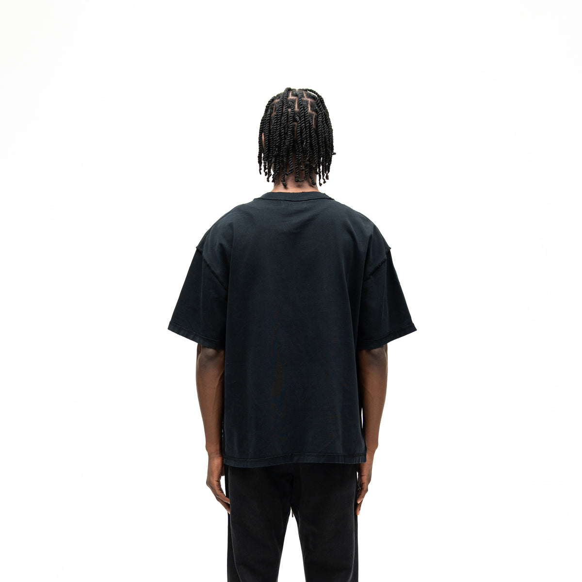 Smoke Tee – Black – Back view on model showing plain black back and relaxed silhouette