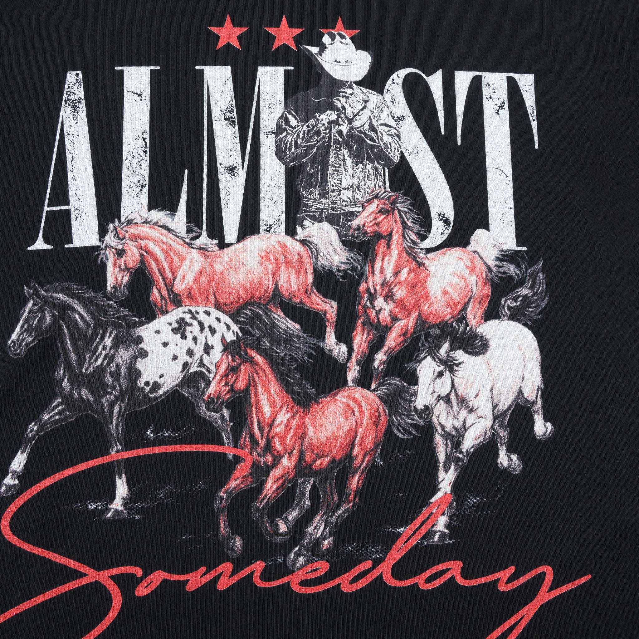 Smoke Tee – Black – Close-up of cowboy and running horses artwork with white Almost lettering and red Someday script