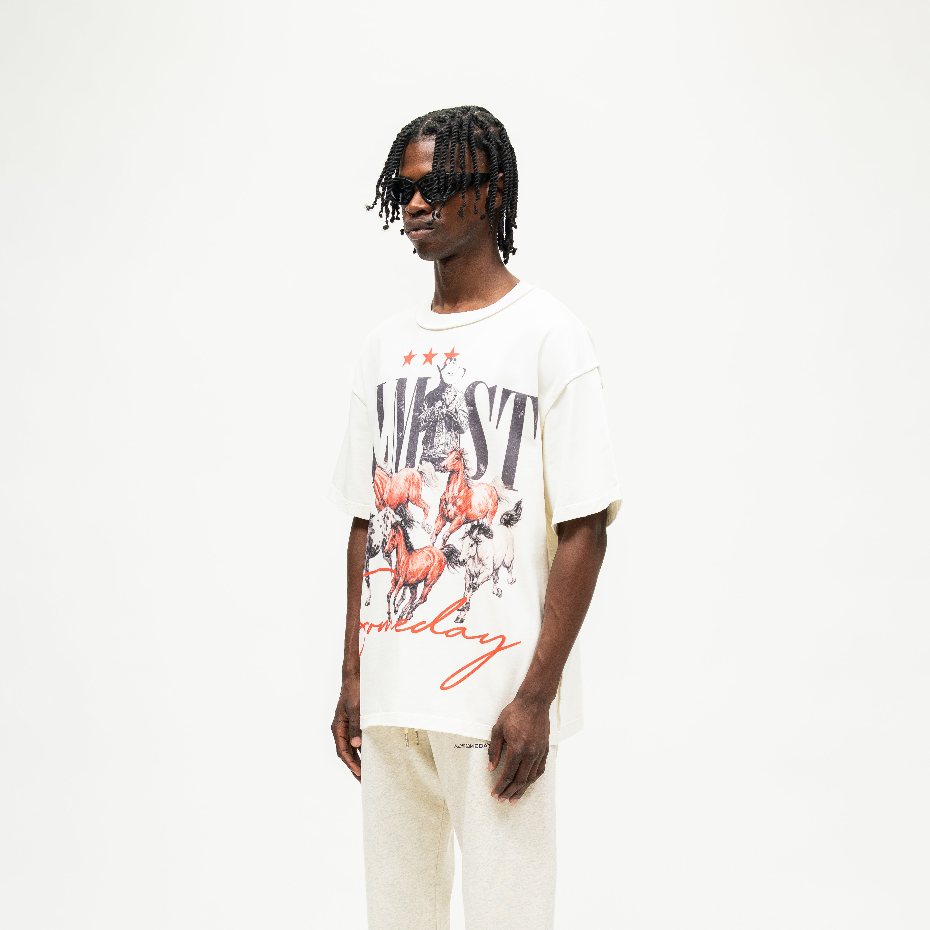 Smoke Tee – Cream – Three-quarter front view on model showing large horse graphic and wide short sleeves