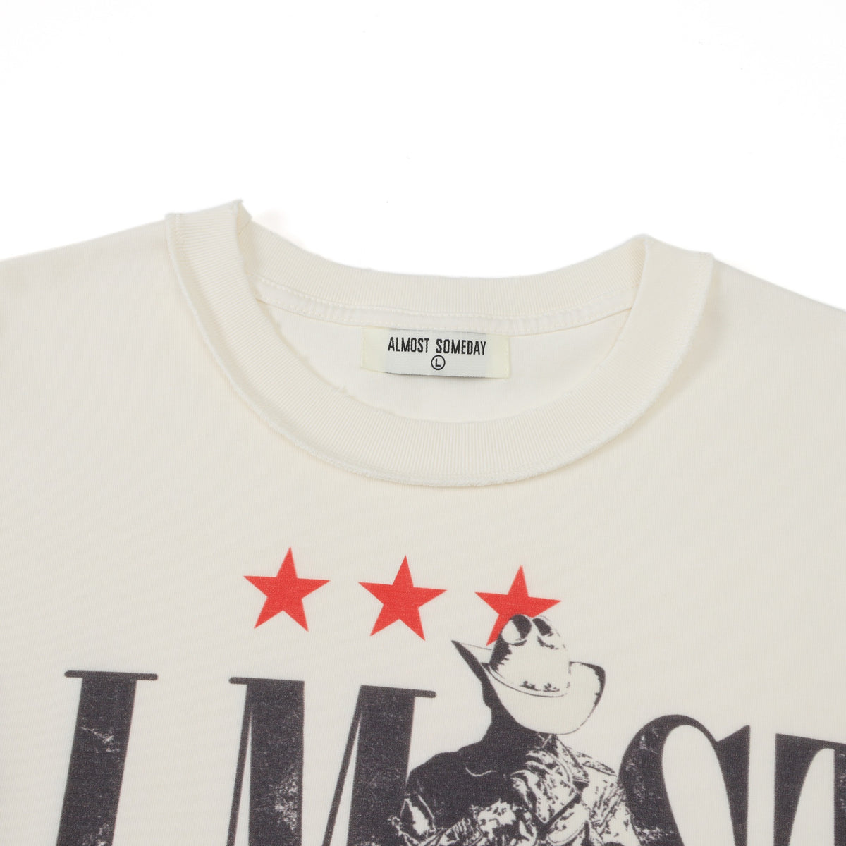Smoke Tee – Cream – Close-up of ribbed crew neckline, Almost Someday neck label, and red stars above cowboy artwork