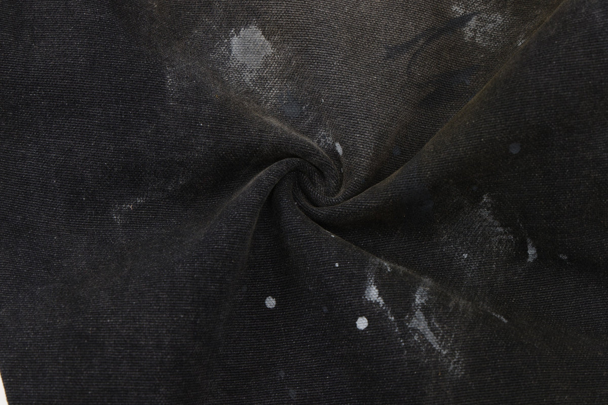 Spade Pants – Black – Close-up of gathered fabric showing washed texture and white paint splatters